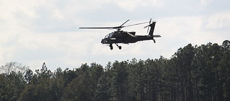 Helicopter flying above tree line